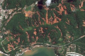 Vista aérea mostra desmatamento e avanço urbano, destacando a importância do monitoramento ambiental com uso de geotecnologia.